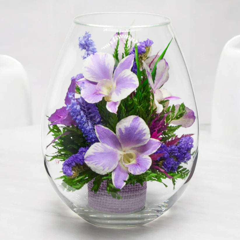 Breathtaking Purple Orchids in a Droplet-Shaped Glass Vase